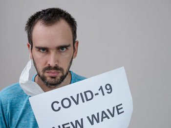 Portrait of young man against white background