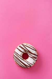 Close-up of heart shape against pink background