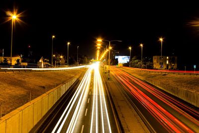 High angle view of light trails on road against sky at night