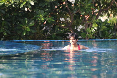 Teenage girl swimming in pool