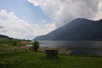 Scenic view of lake against cloudy sky