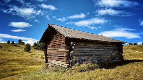 Built structure on field against sky