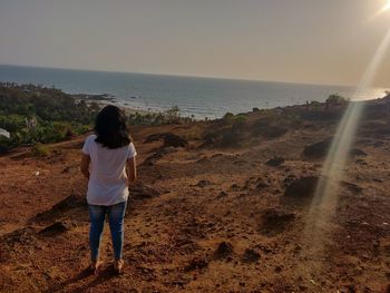 Rear view of woman looking at sea shore