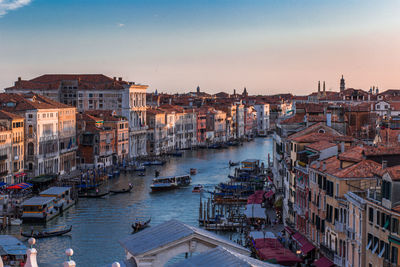 High angle view of boats moored in city against sky