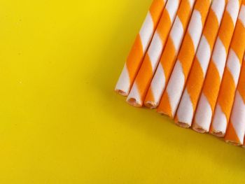 High angle view of orange cake against yellow background