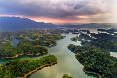 Scenic view of lake against sky at sunset