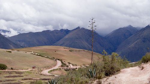 Scenic view of land and mountains against sky