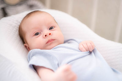 Close-up of baby boy sleeping on bed at home