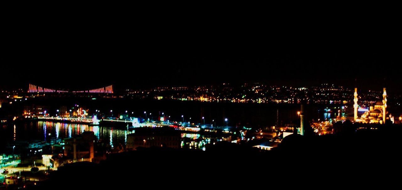 illuminated, night, water, reflection, copy space, clear sky, city, built structure, river, sea, building exterior, architecture, dark, lighting equipment, cityscape, harbor, nautical vessel, light - natural phenomenon, waterfront, glowing