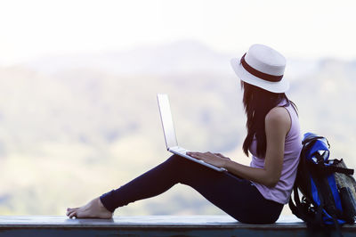 Side view of woman using mobile phone