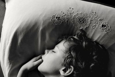 High angle view of boy sleeping on bed