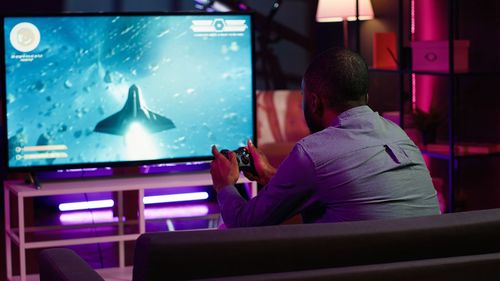 Rear view of woman using mobile phone while sitting in train