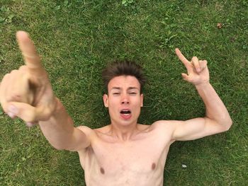 Portrait of smiling young woman on grassy field