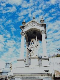 Low angle view of statue against cloudy sky