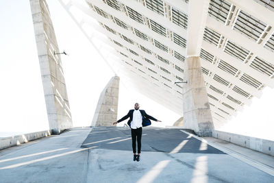 Man walking on modern building in city