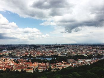 High angle shot of cityscape against cloudy sky