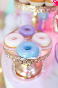 Multicolored donuts in glaze on a golden tray