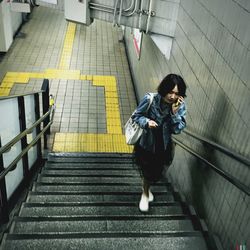 Full length of woman standing by railing