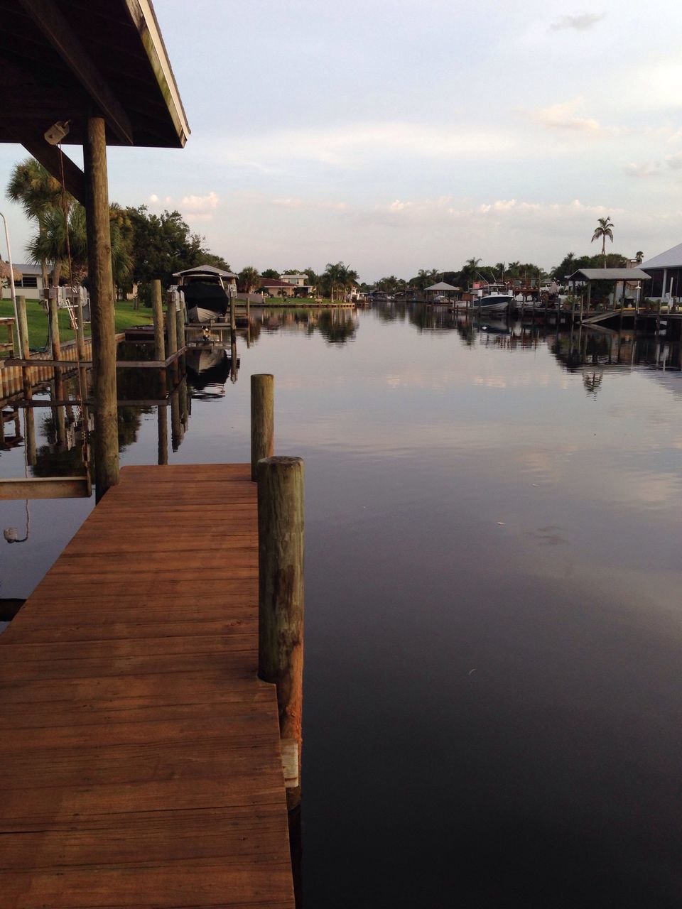 water, wood - material, pier, sky, built structure, lake, reflection, wood, nautical vessel, architecture, wooden, jetty, tranquility, boat, day, river, building exterior, cloud, nature, waterfront