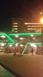 People on illuminated street at night