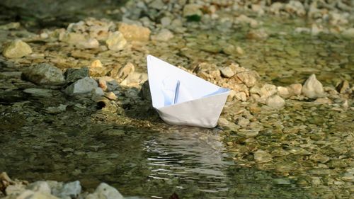 Close-up of paper boat floating on lake