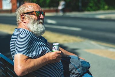 Midsection of man holding ice cream in city