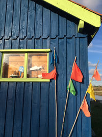 Multi colored flags on wall against building