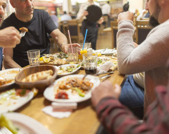 Midsection of man eating food