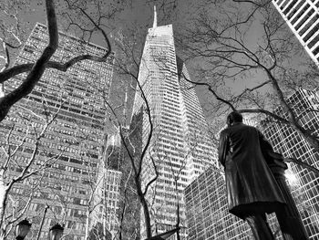 Low angle view of bare tree against building