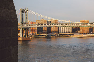 Brooklyn bridge over east river against sky