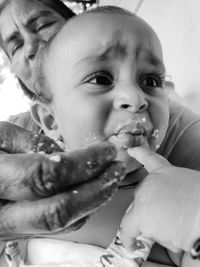 Close-up portrait of cute baby eating