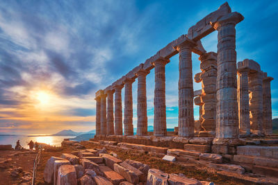 Poseidon temple ruins on cape sounio on sunset, greece