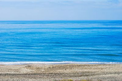 Scenic view of sea against clear blue sky