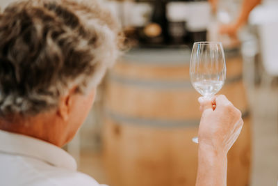 Side view of man holding wineglass