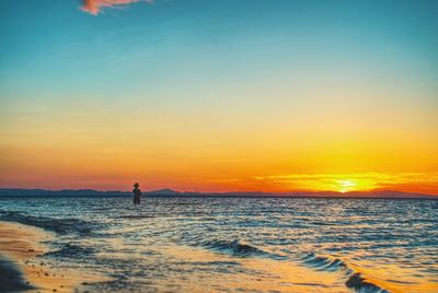 Scenic view of sea against sky at sunset