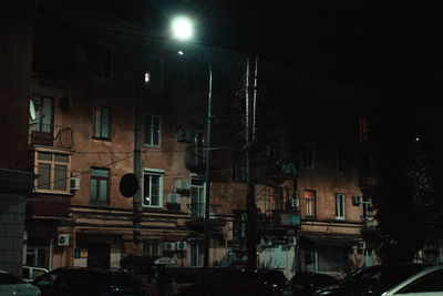 Street amidst buildings in city at night