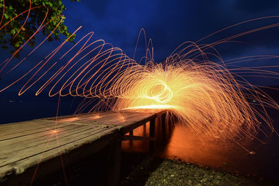 Blurred motion of illuminated bridge at night