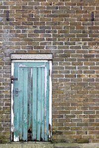 View of blue door on brick wall