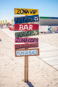 Close-up of information sign on beach