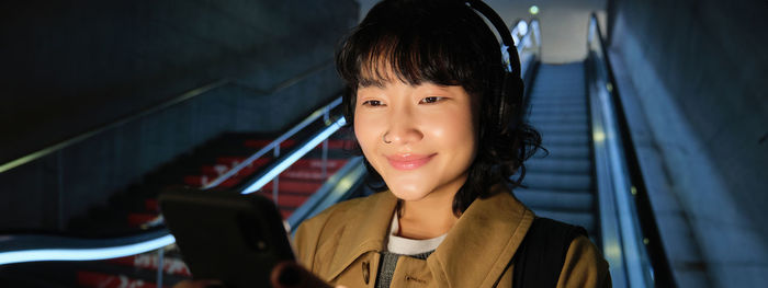 Portrait of young woman using mobile phone