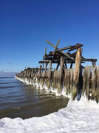 Lifeguard hut on beach against clear sky