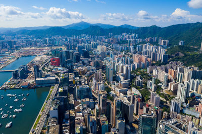 Aerial view of buildings in city against sky