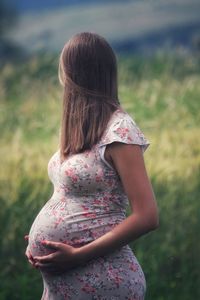 Pregnant woman standing on land
