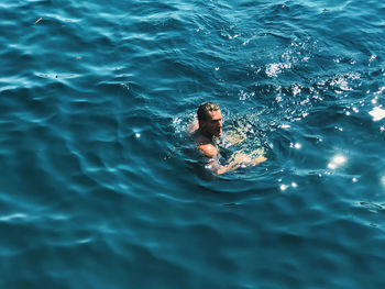 High angle view of man swimming in sea