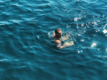 High angle view of man swimming in sea