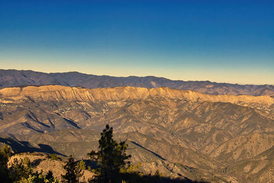 Scenic view of dramatic landscape against clear blue sky