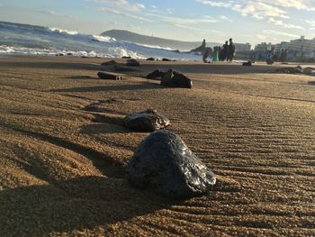 Surface level of sand on beach against sky