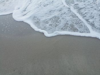 Close-up of tire tracks on beach