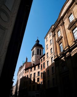 Low angle view of buildings against blue sky