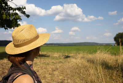 Rear view of woman looking away on field